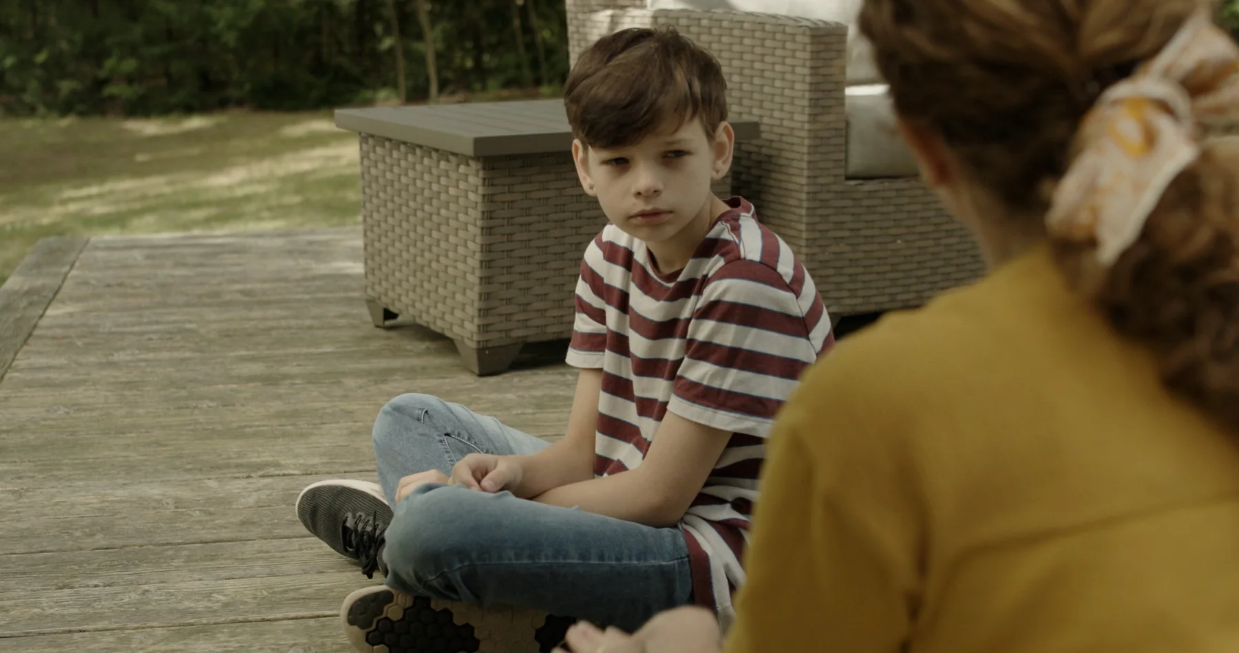 David sitting on a wooden deck