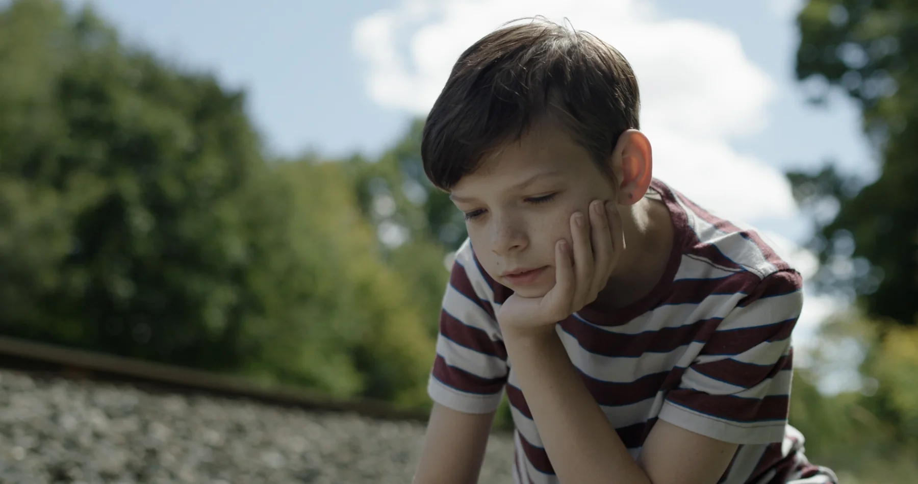 David beside railroad tracks