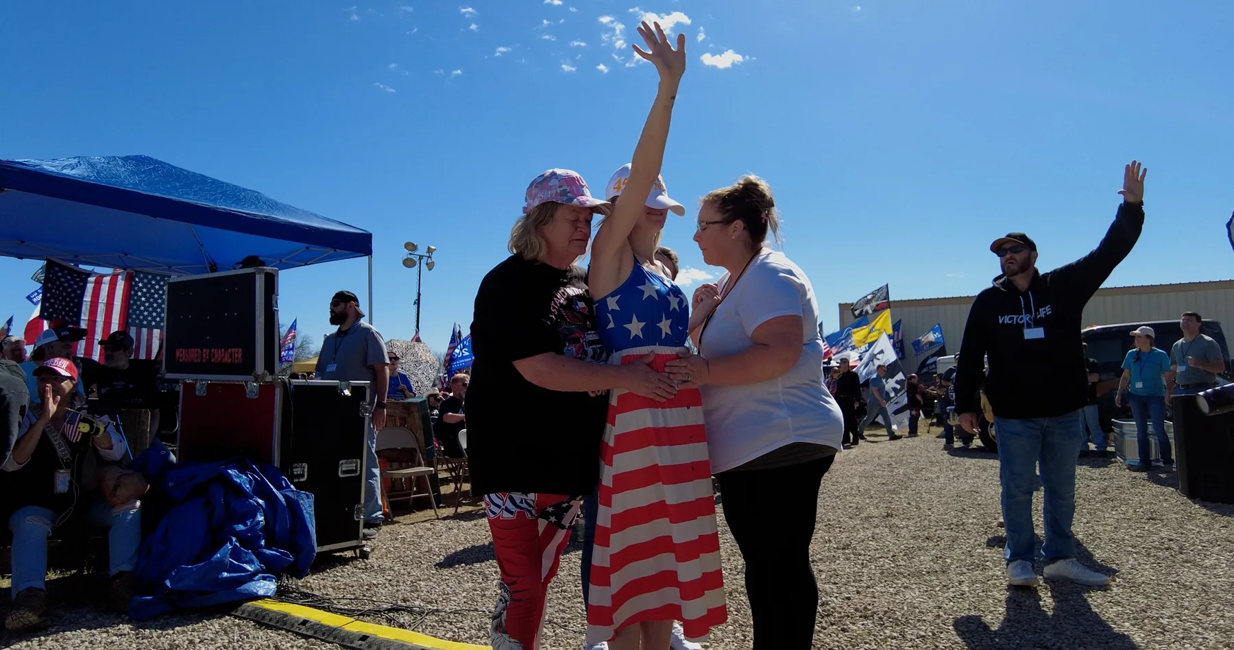 People gathered in prayer at a roadside event
